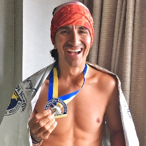 Trainingpeaks Coach And Ironman Finisher Frank Campo Image Of Trainingpeaks Coach Frank Campo With An Ironman Medal After Finishing An Ironman Race And Training