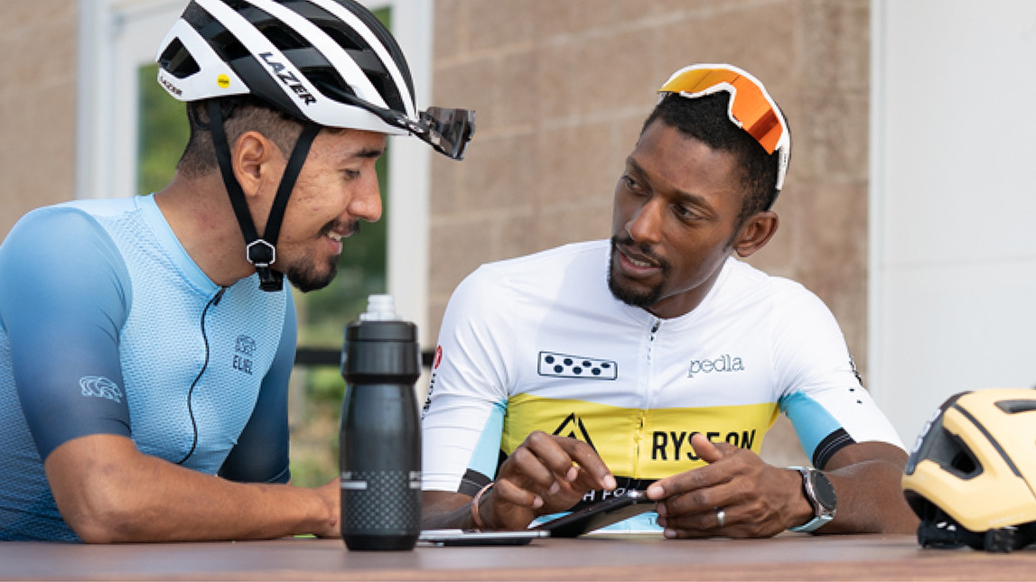 One On One Coaching Tailored To You. Coach Showing Male Cyclist How To Train With Trainingpeaks.