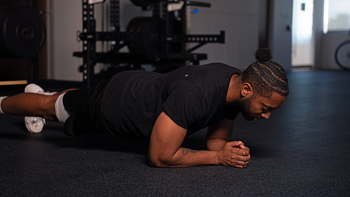 The Benefits Of Strength Training Diverse Male Athlete Downward Plank During A Strength Training Workout